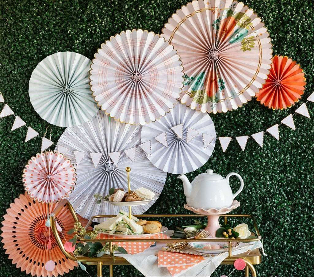 Black and white paper fans and banners on a fireplace mantel