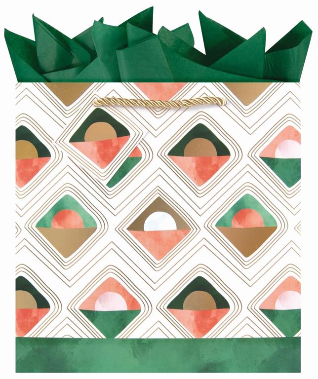 Teal green gift bag with multi-colored ornaments and Be Merry written. red ribbon handle and gold tissue paper sticking out the top