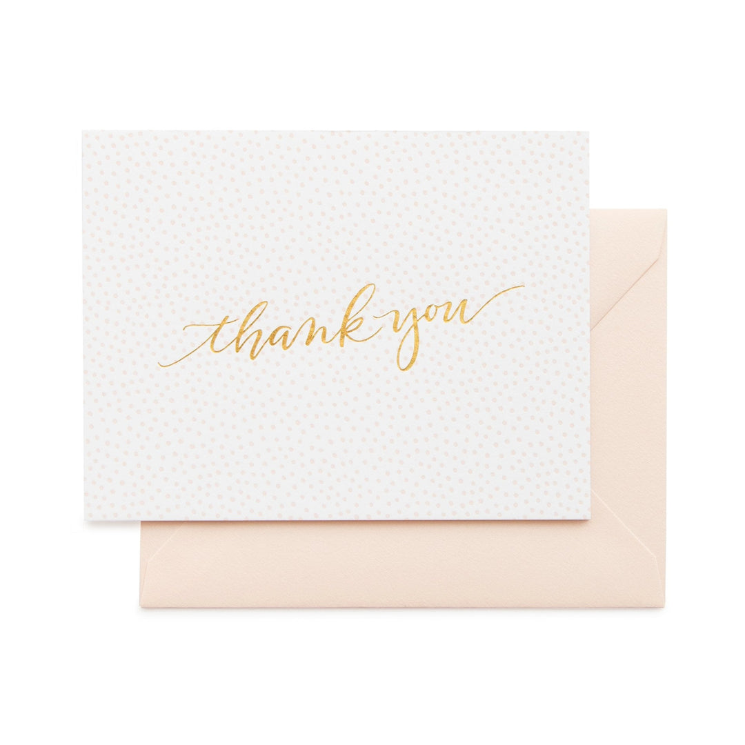 pink envelope, white card allover pink polka dots and gold thank you printed on front
