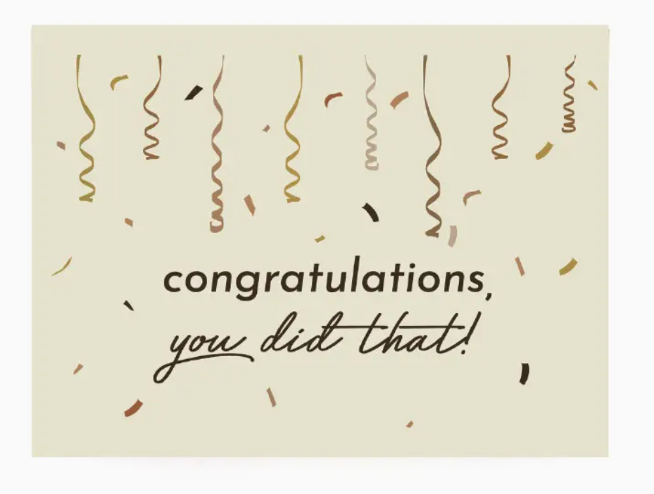 Beige colored greeting card with multi-color printed confetti and streamers falling from the top of the card edge with the text "congratulations you did that!" in brown