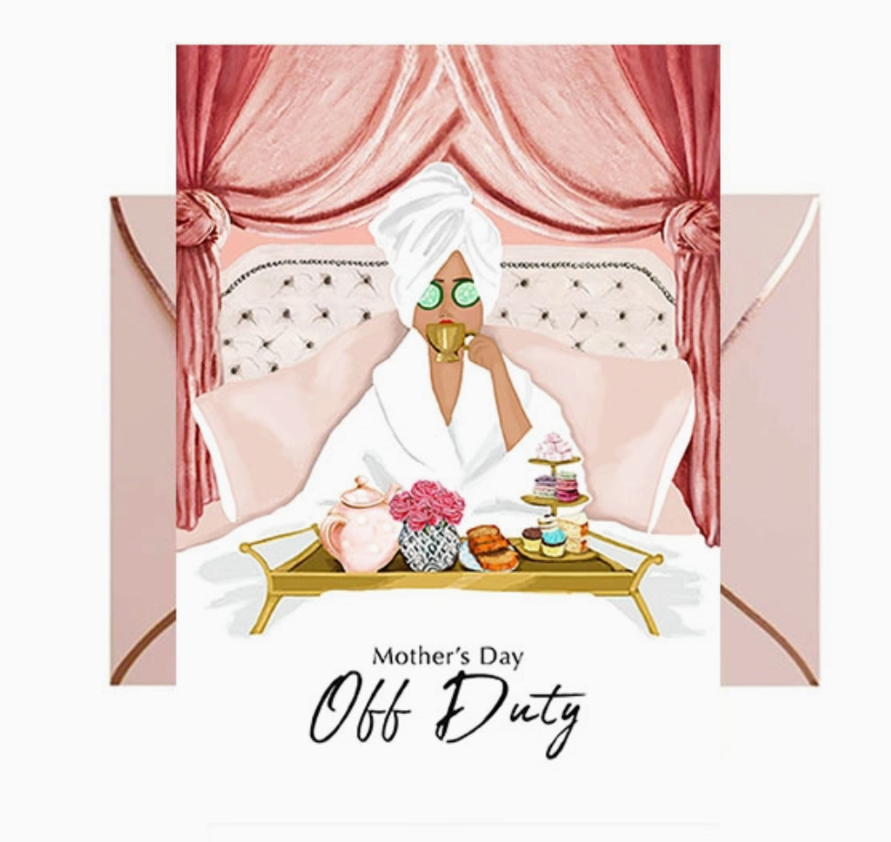 Greeting card featuring an illustration of a woman in a spa robe and turban sitting on a pink upholestered bed, sipping tea from a gold cup, with a gold tray topped with pink roses and dessert platters. Pink envelope with rose gold foil trim on a white background