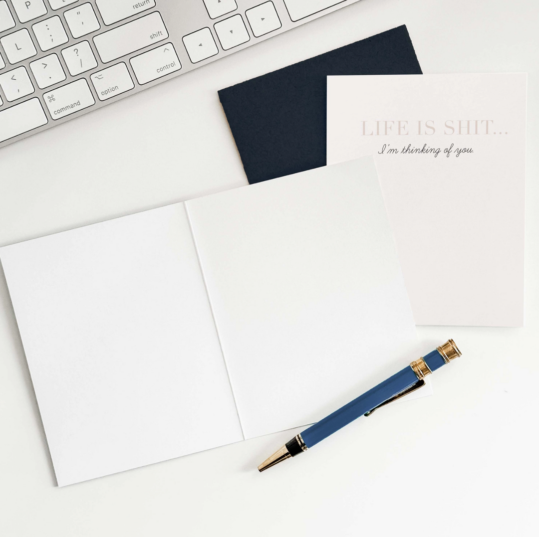 White greeting card with text &