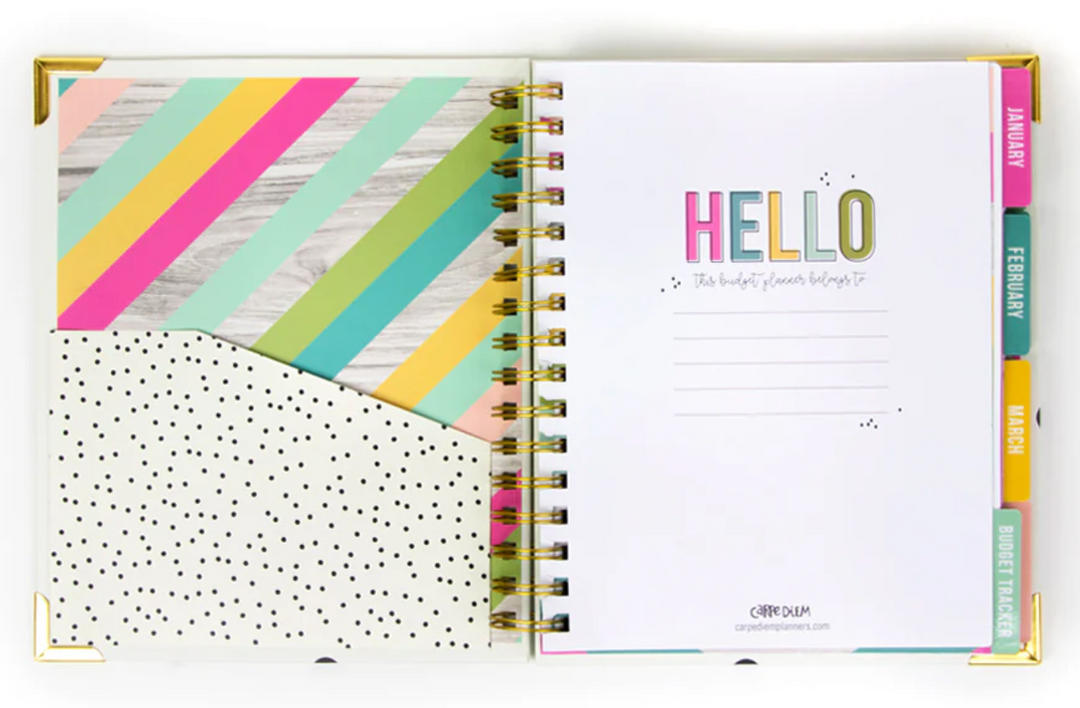 Open planner with colorful cover and polka dot pocket, welcome-introduction page, and colorful month tabs