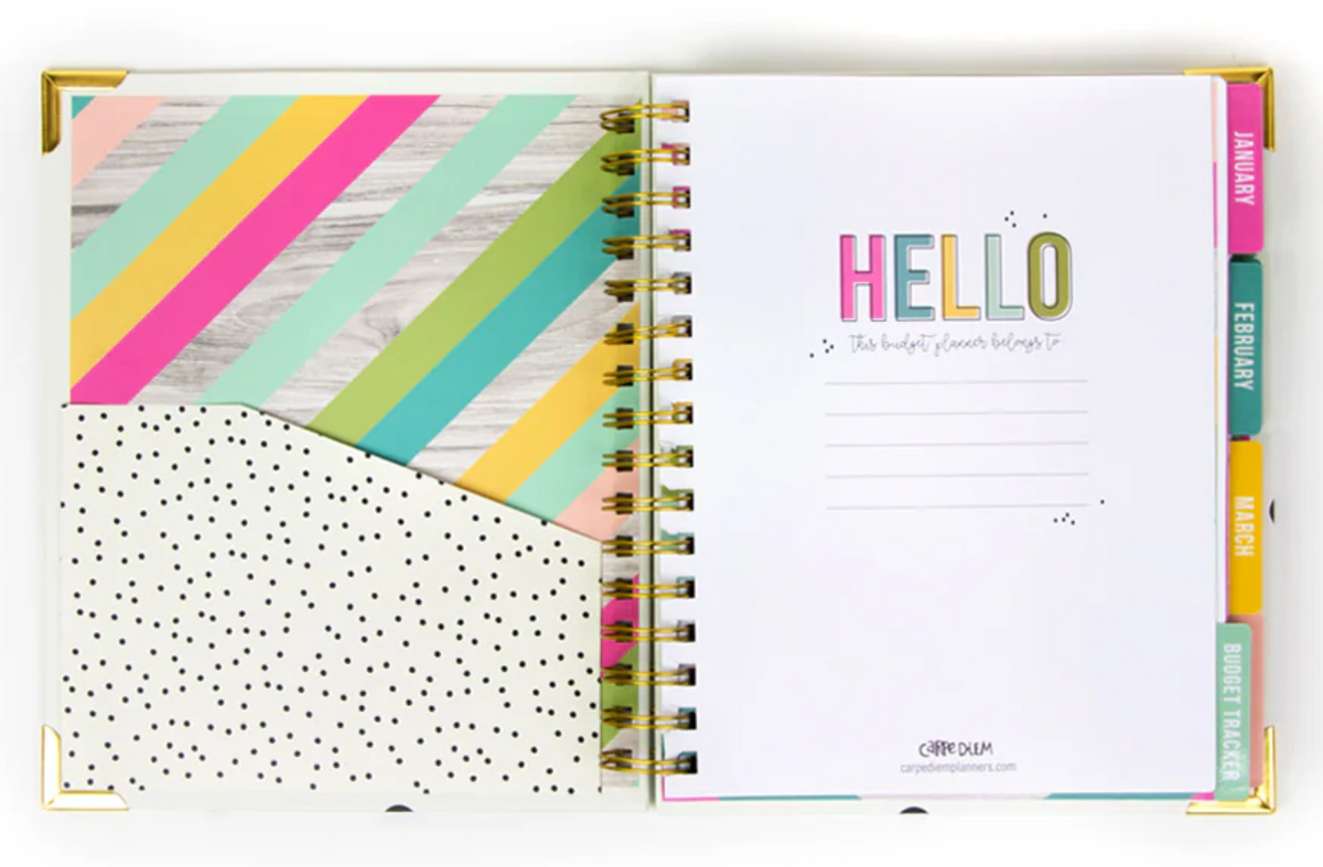 Open planner with colorful cover and polka dot pocket, welcome-introduction page, and colorful month tabs