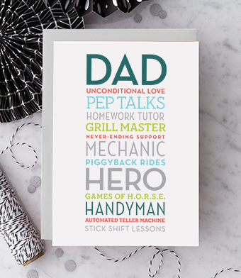 White greeting card with multi-color text and font styles that reads "Dad, unconditional love, pep talks, homework tutor, grill master, never-ending support, mechanic, piggyback rides, hero, games of h.o.r.s.e, handyman, automated teller machine, stick shift lessons. Paired with a metallic silver envelope.