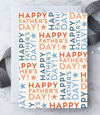 An off-white greeting card with a colorful 'Happy Father's Day' text all-over pattern, accompanied by a silver shimmered envelope.