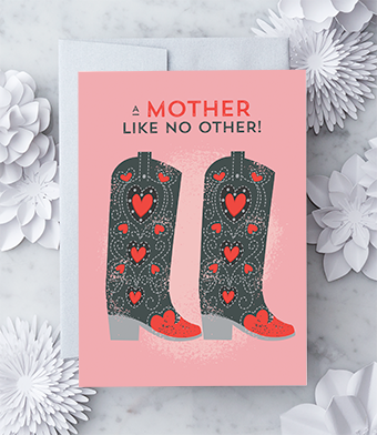 Greeting card with a pink background featuring a pair of black and red cowboy boots with heart patterns, and text that reads "A mother like no other!" paired with a metallic silver envelope