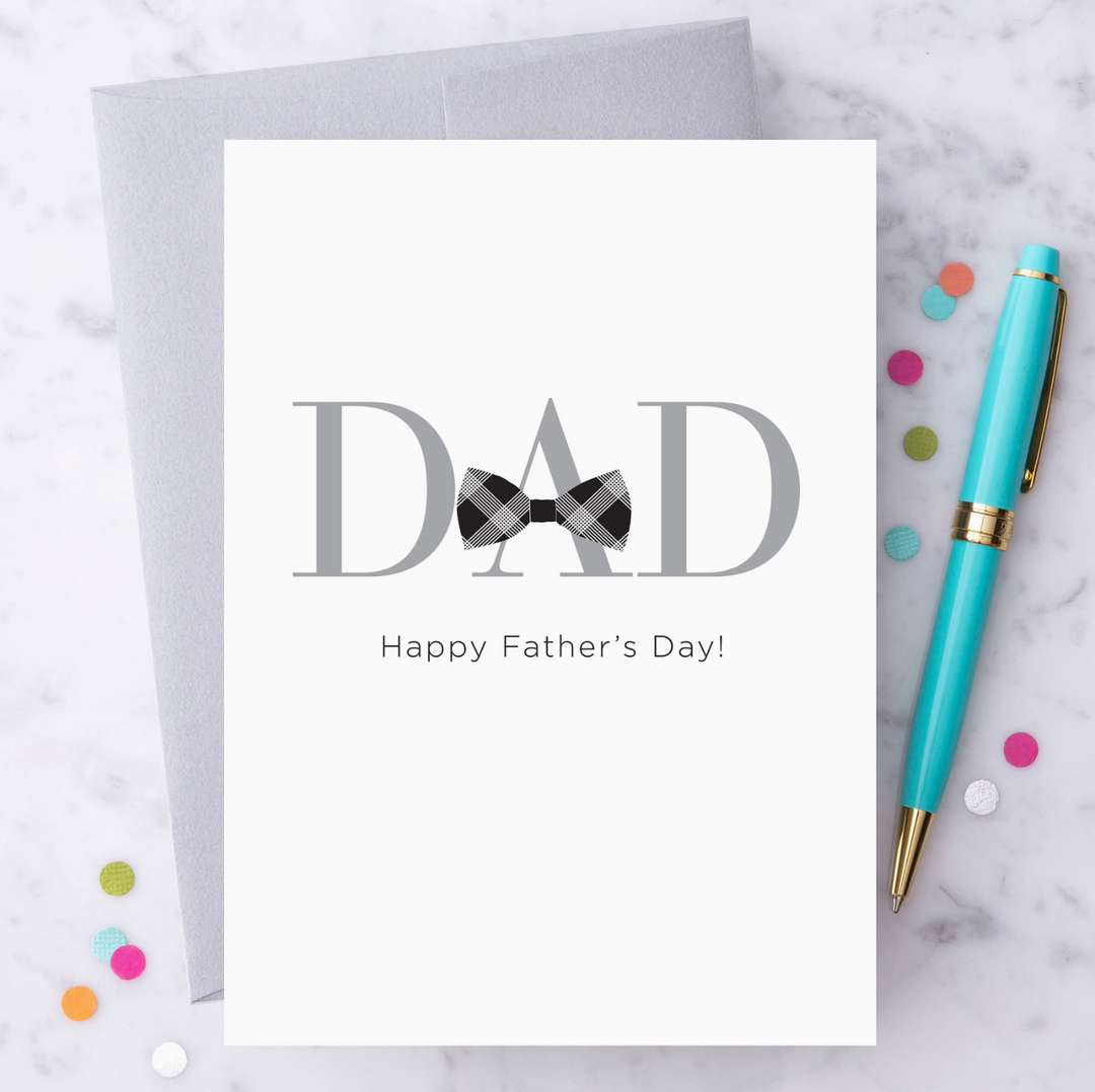 White greeting card with silver foil print that reads "Dad Happy Father&