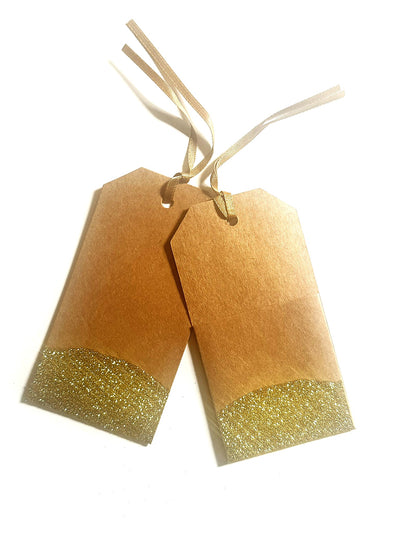 A set of 2 Kraft paper gift tags with pocket on backside dipped in gold glitter