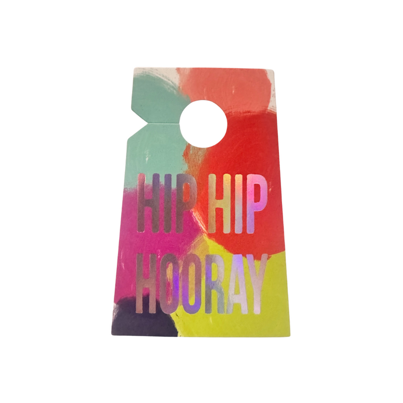Neon red, aqua, pink, fuchsia, and green splash print on a beard clip style gift tag with an iridescent foil print that reads Hip Hip Hooray.