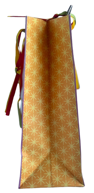 Side view of a gift bag, orange-yellow color with yellow star all-over print