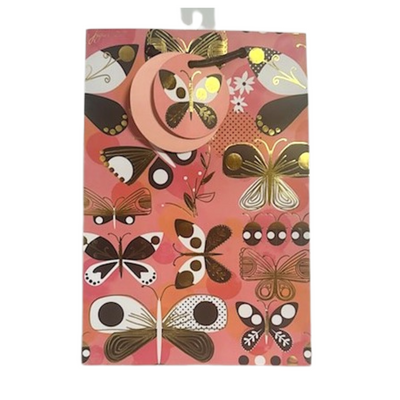 Pink background, pinks, black, white, and gold foil butterfly and ladybug printed gift bag