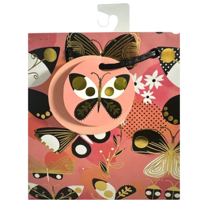 Pink background, pinks, black, white, and gold foil butterfly and ladybug printed gift bag and gift tag