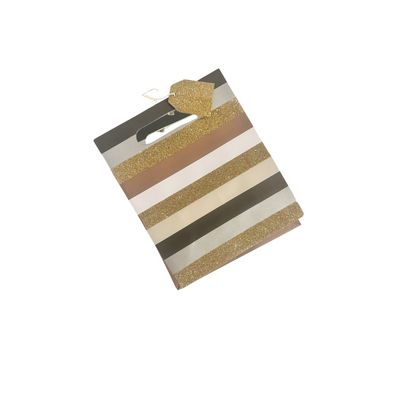 Black, white, glitter gold, bronze, and silver striped gift bag with glitter gold gift tag attached