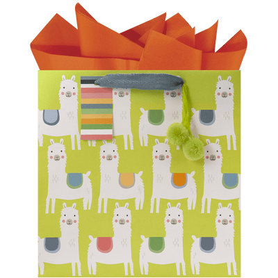 allover llama print with colorful saddles on a lime green gift bag, lime green pom-poms accent, a multi-color stripe gift tag and orange tissue paper