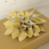 Glitter gold and silver lotus flower style gift bow on a brown gift box