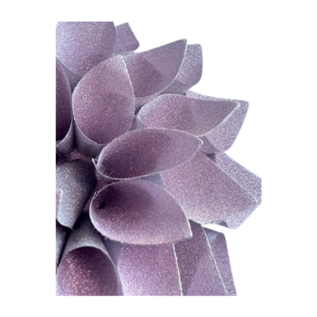 Close up of glittery lavender colored lotus shaped gift bow