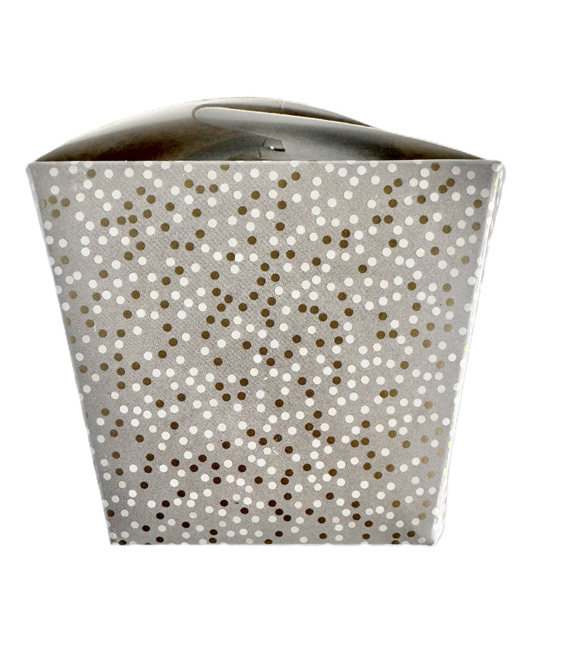 A close-up image of a charcoal gray take-out style box with a tonal grey and gold polka dot pattern.