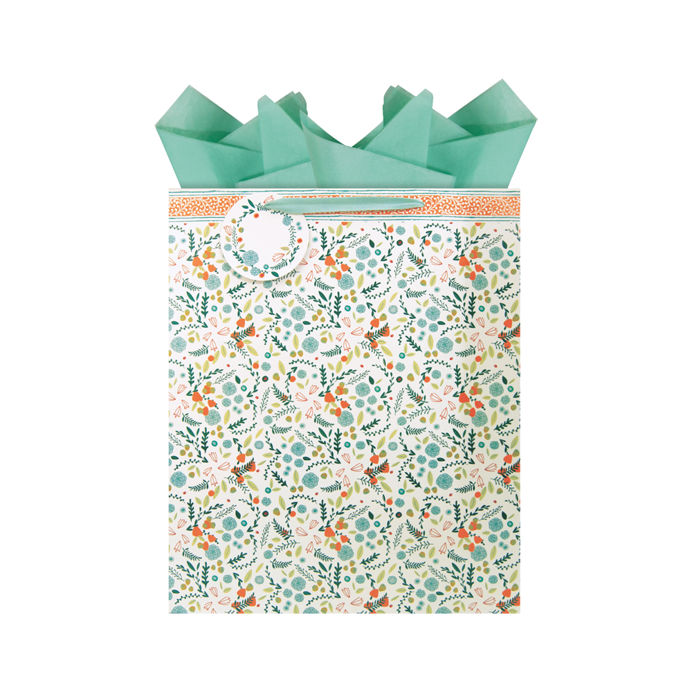 teal, blush, orange, and green all over floral print patterned extra-large gift bag with teal tissue paper and a matching gift tag.