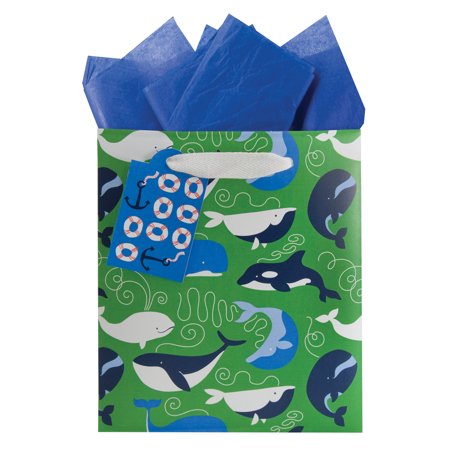 Green gift bag with an all-over whales and dolphin print, white ribbon handle, blue gift tag and tissue paper