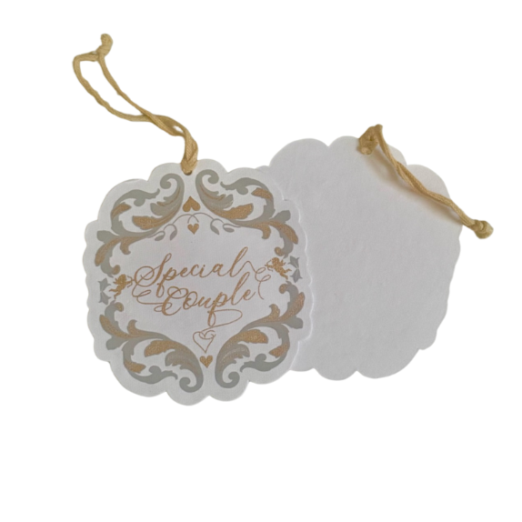 White gift tag with Baroque inspired shape and silver and gold print art detail and gold ribbon. Backside is blank
