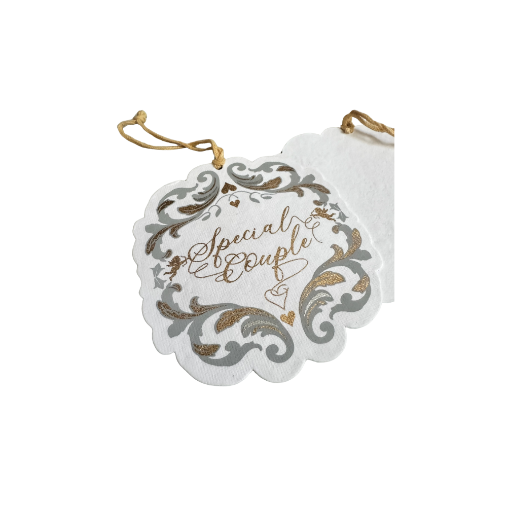Close up of a Baroque inspired gift tag, cotton paper, gold ribbon, silver and gold printed art that says special couple