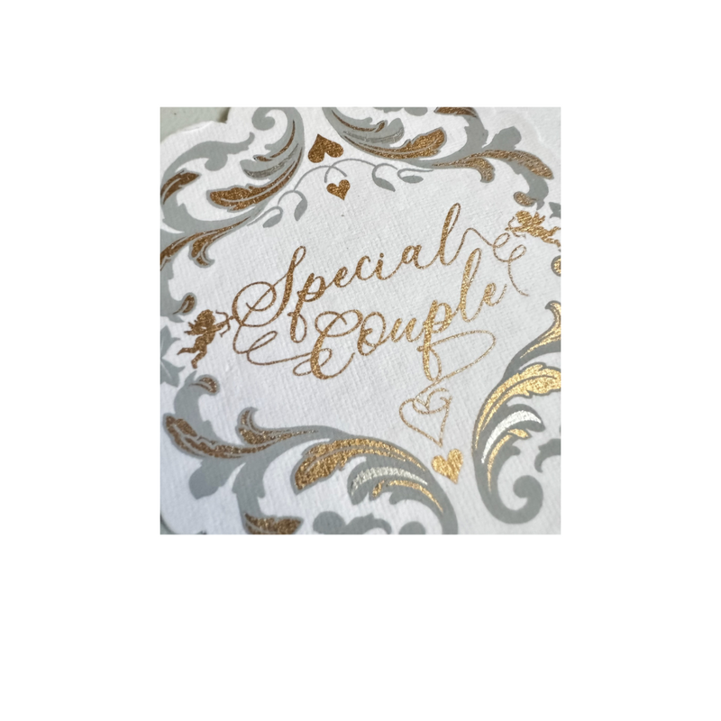 Close up of a Baroque inspired gift tag, cotton paper, matte silver and gold foil printed art that says special couple