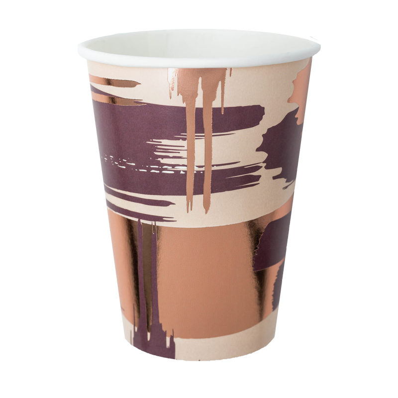 A paper cup with a brushstroke pattern in mauve, taupe, and tan colors with rose gold accents.