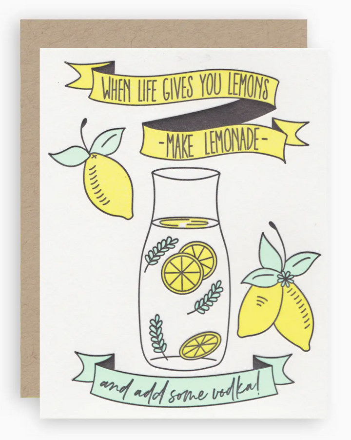 White greeting card with illustrations of ribbons, lemons, and decanter of water with lemon slices and mint leaves and text that reads "when life gives you lemons, make lemonade, and add some vodka!" paired with a kraft brown envelope.