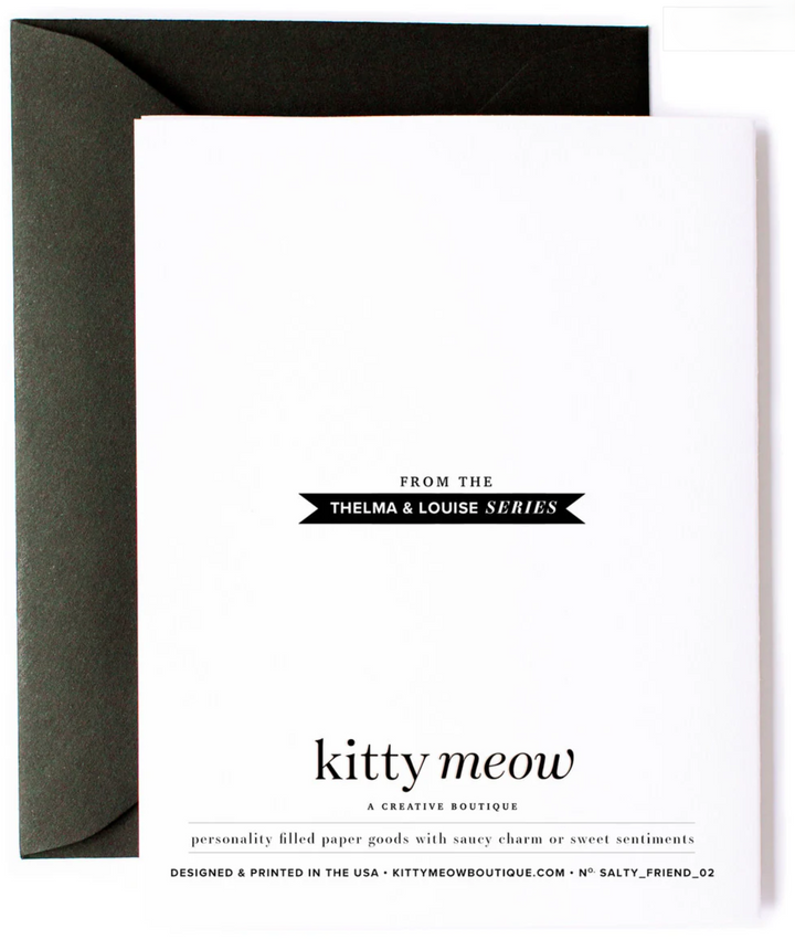 Backside of greeting card with the text "From the Thelma &amp; Louise series, Kitty Meow a creative boutique, personality filled paper goods with witty charm or sweet sentiments. Designed and printed in the USA - kittymeowboutique.com - no. salty friend 02 with a black envelope