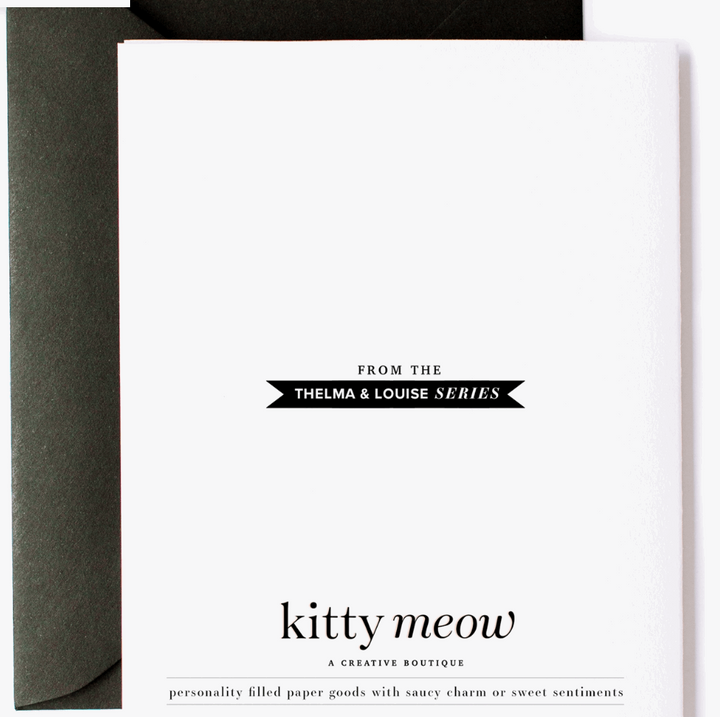 Backside of greeting card with the text "From the Thelma &amp; Louise series, Kitty Meow a creative boutique, personality filled paper goods with witty charm or sweet sentiments. Designed and printed in the USA - kittymeowboutique.com - no. salty friend 03 with a black envelope