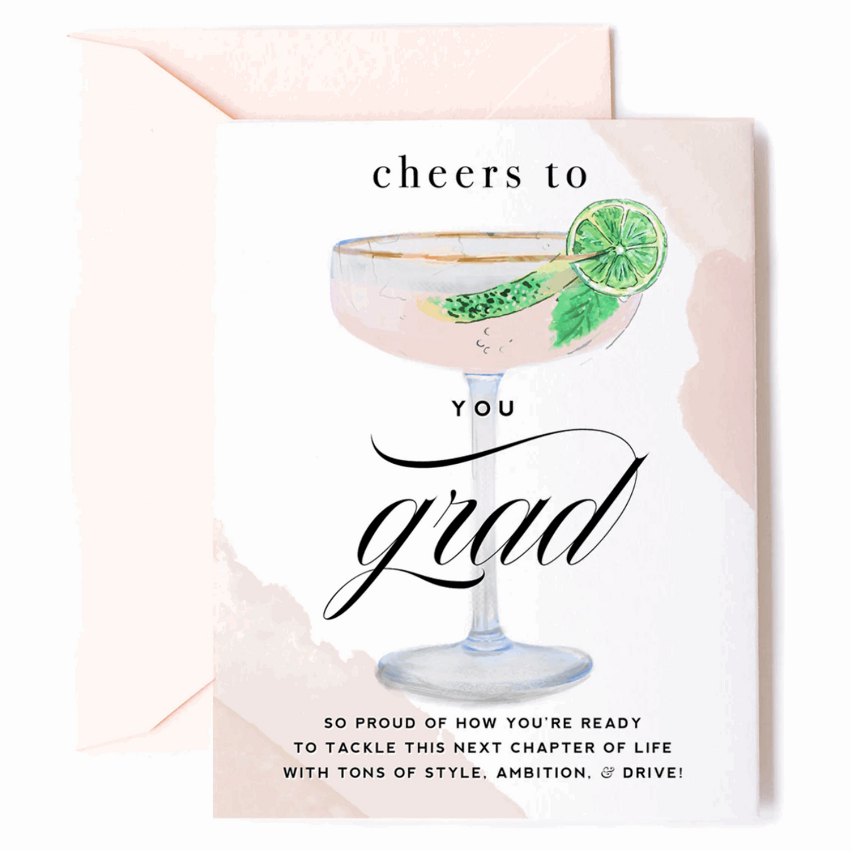Greeting card with an illustrated filled gold-rimmed coupe-style glass with mint leaf and lime slice on the rim and caption that reads "Cheers to YOU Grad. So proud of how you're ready to tackle this next chapter of life with tons of style, ambition, & drive!". Paired with a peach envelope