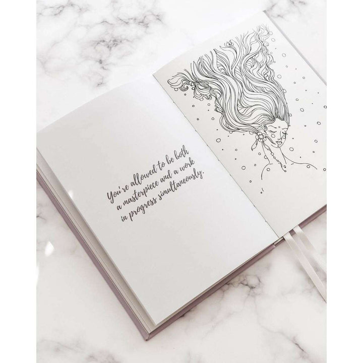 A journal opened to a page with the quote "you&