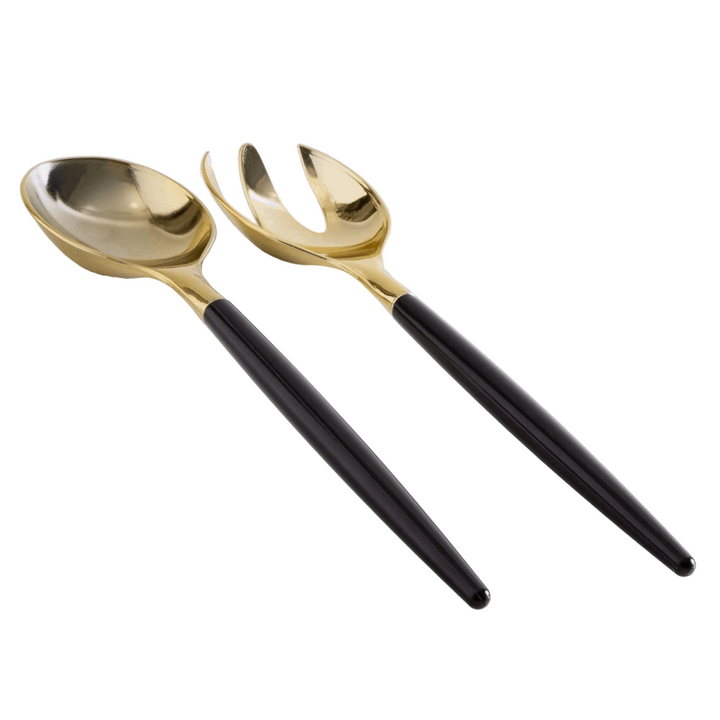 White background, side view of a black-handled salad serving set with gold tops. 1 salad serving fork next to 1 salad serving spoon