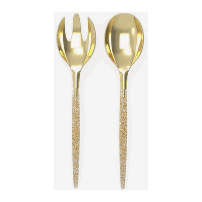 White background, a glitter-filled, clear-handled salad serving set with gold tops. 1 salad serving fork next to 1 salad serving spoon