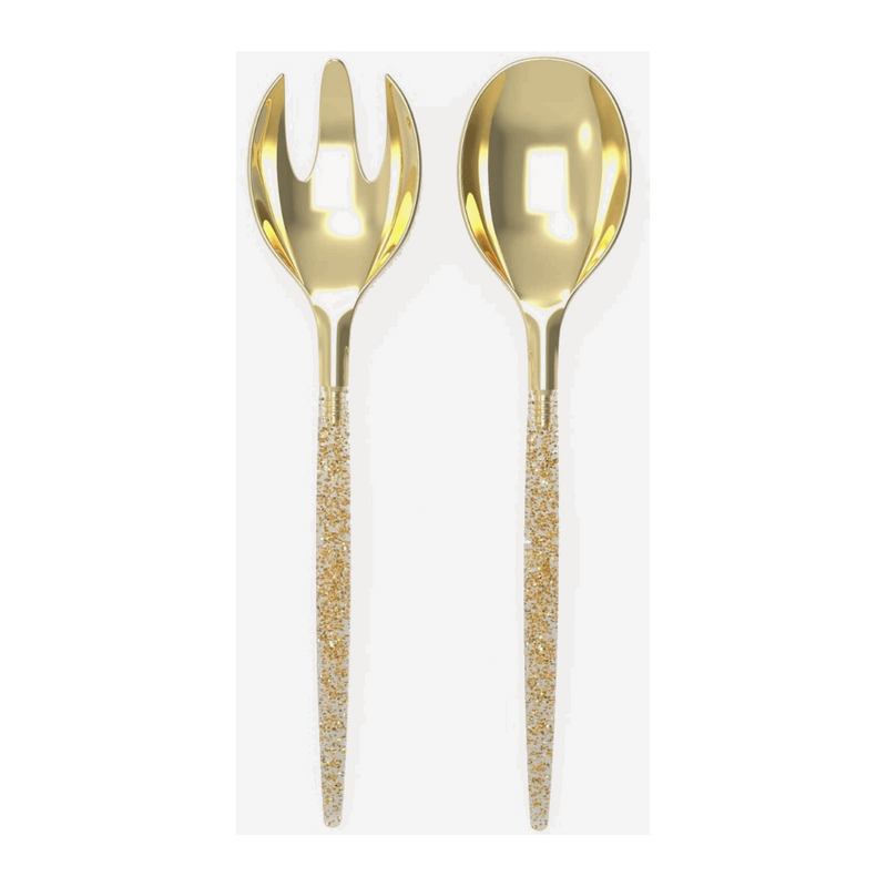 White background, a glitter-filled, clear-handled salad serving set with gold tops. 1 salad serving fork next to 1 salad serving spoon