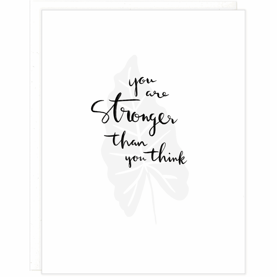 White greeting card with black text that reads "You are Stronger Than You Think" over a letterpress plant leaf with a white envelope
