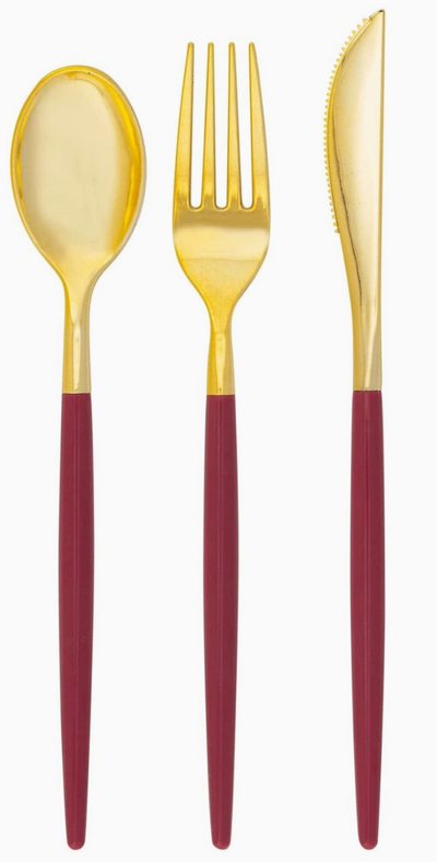 white background with cranberry color handle with gold cutlery set, showing a spoon, fork, and knife