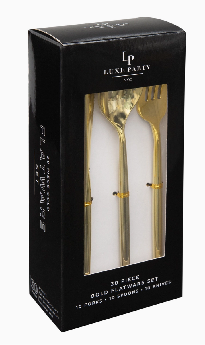 Gold flatware set in a packaging box on a white background