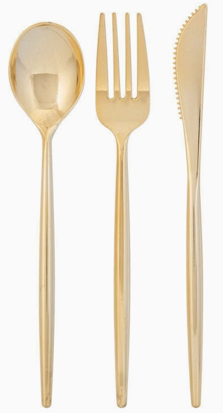 Set of gold cutlery including a spoon, fork, and knife on a white background