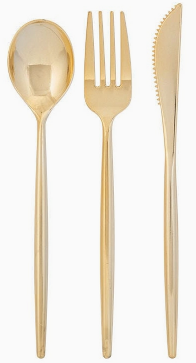 Set of gold cutlery including a spoon, fork, and knife on a white background