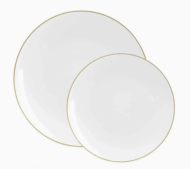 Two white plates with gold rims on a white background