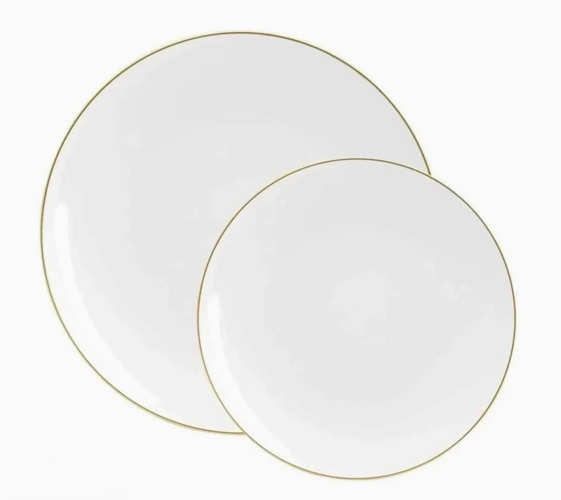 Two white plates with gold rims on a white background
