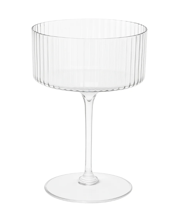 plastic clear ribbed coupe shaped champagne glass on a white background