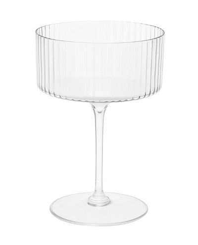 plastic clear ribbed coupe shaped champagne glass on a white background