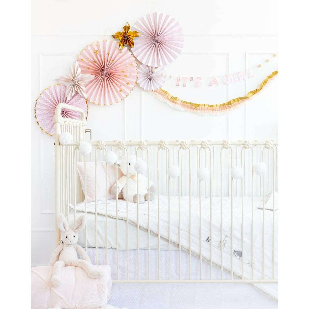 A set of pink, white, and gold party fans of different sizes, an it&