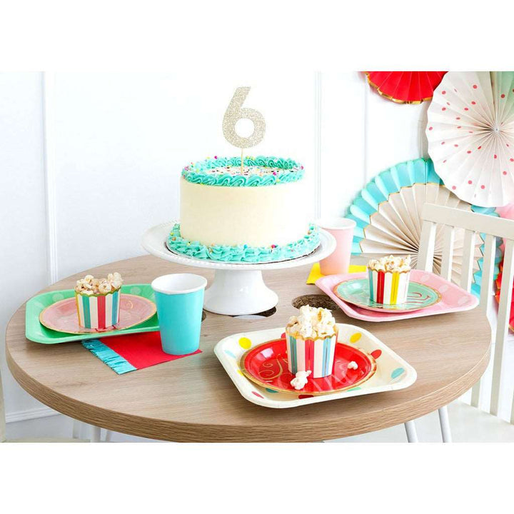 Table setting with white and mint green birthday cake with a 