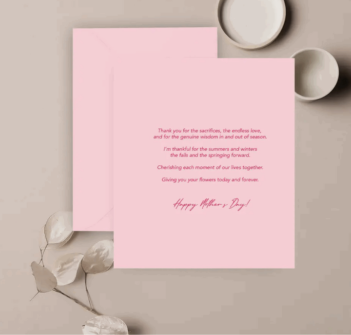 light pink card with hot pink text with a heartfelt message thanking a mother for all her love and support against a neutral background with decorative objects