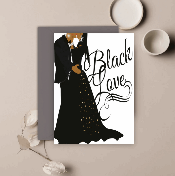 White greeting card with an illustration of a man and woman wearing black formal attire, embracing for a kiss, and a text that reads Black Love in black script font.