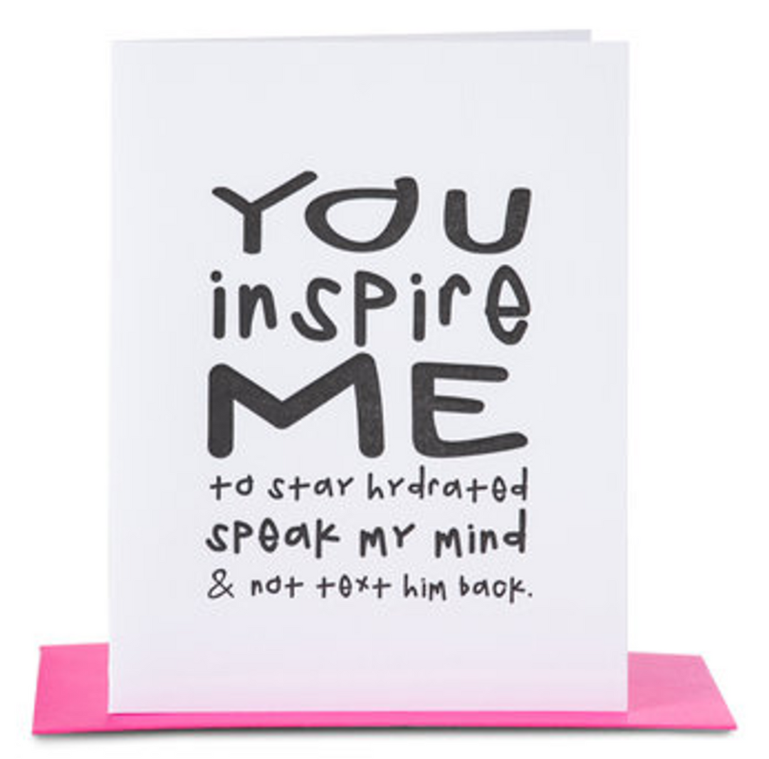 White greeting card with black text that reads "you inspire me to stay hydrated speak my mind and not text him back" paired with a hot pink envelope
